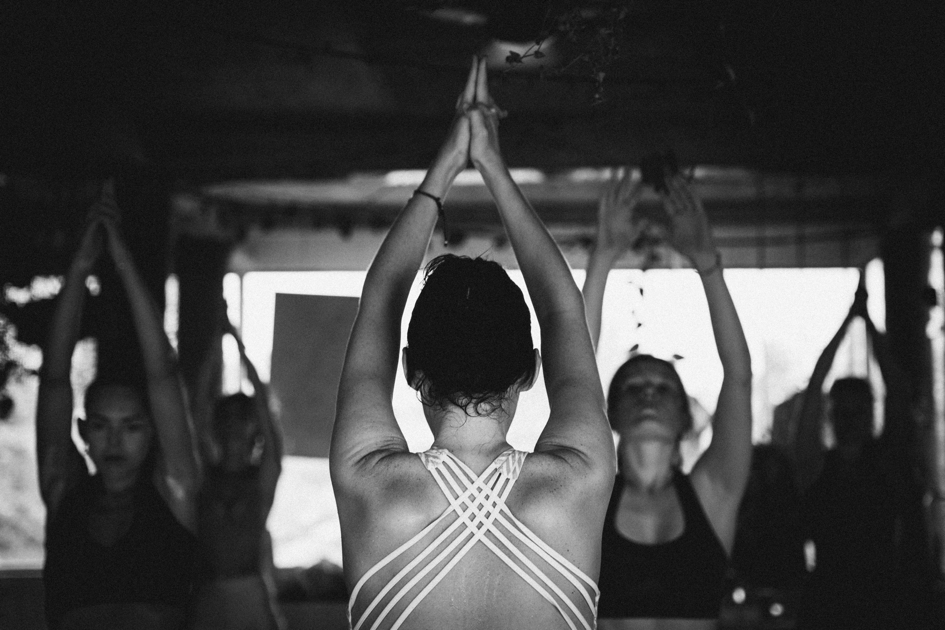 People practicing together, arms raised in unison